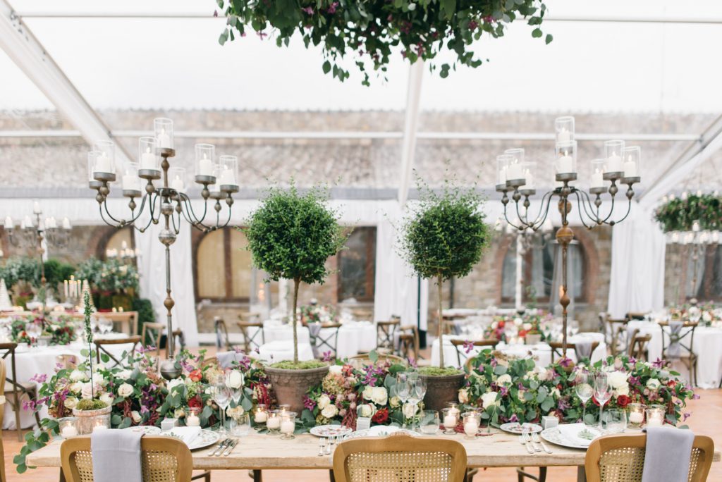 lush and floral decor for bare table tuscan dinner. destination wedding in tuscany